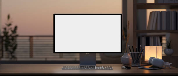 istock A computer mockup on a hardwood desk in a modern home office with a large window and balcony. 1978942763