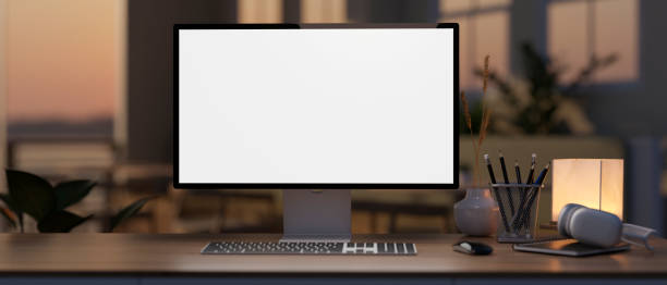 istock A white-screen computer mockup on a hardwood desk in a modern home office during sunset time. 1978943284