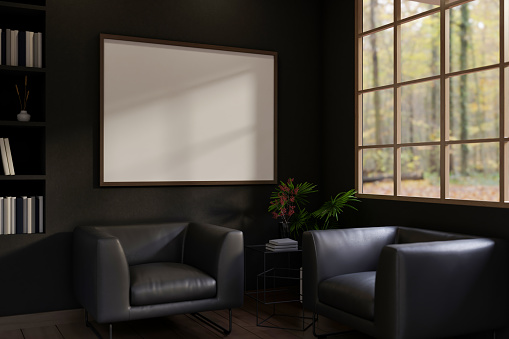 Interior design of a modern black living room with black leather armchairs, a frame mockup attached to the black wall, and a large window. 3d render, 3d illustration