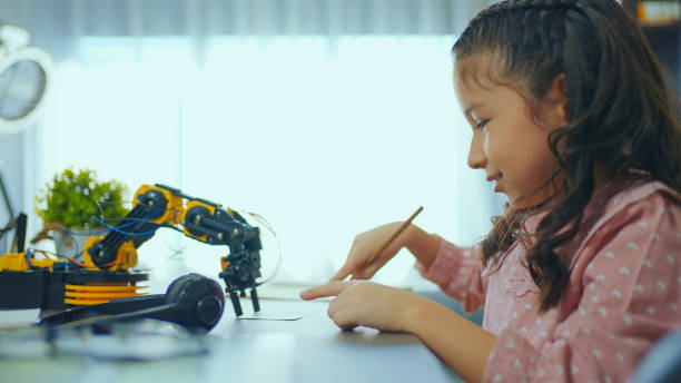 istock Little Girl Building Robotic Arm At School 1978990029