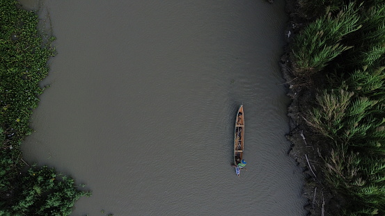 Aerial View of Small Fishing Boats Floating on the River in the Forest