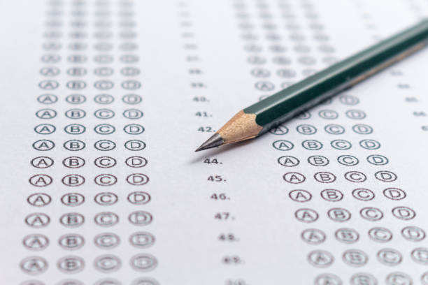 Answer sheet for a test with a pencil, concept for public exams and entrance exams. Photograph of an answer sheet for an entrance exam with a pencil. high school enrollment stock pictures, royalty-free photos & images