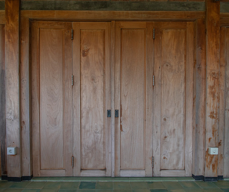 brass door knobs on wooden door of house