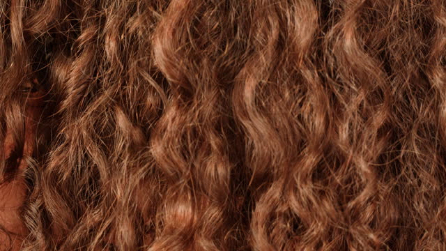 Brown brunette curly wavy hair texture close-up macro. Hairstyle. Body spa and relax ritual self and hair care