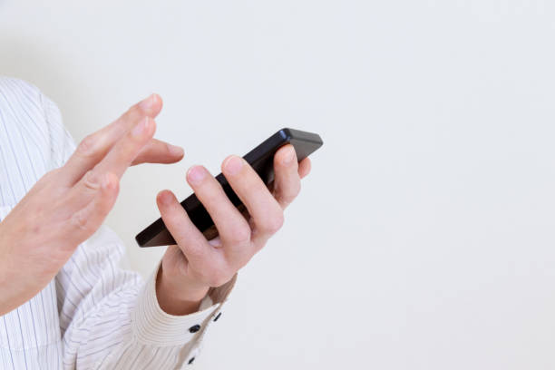 istock A man in a white shirt using a smartphone 1979120166