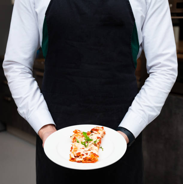 istock Waiter Serving Plate of Fresh Lasagna 1979131578