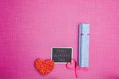 Pink Valentines Day flat lay with chalk board, rice treat, heart ribbon and light blue and lavender giftbox partially open