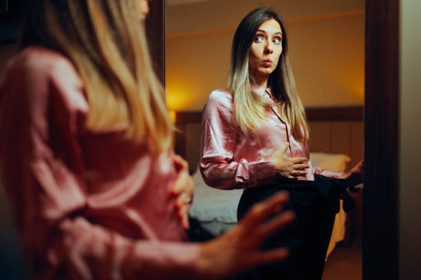 istock Woman Losing Weight Trying on old Pants 1979175326
