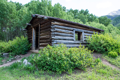 Aspen, Colorado, USA – July 3, 2023: Remains of a log cabin in Ashcroft ghost town near Aspen Colorado