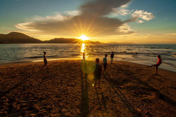 Banda Aceh, Indonesia. April 14, 2016.\n\nA group of young people took advantage of the afternoon until sunset to play ball on Ulee Lheu beach, Banda Aceh city. Ulee Lheu Beach is one of the water tourism destination spots, culinary tourism with sharia nuances in Banda Aceh.