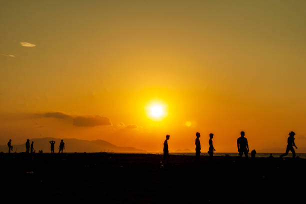 Banda Aceh, Indonesia. February 16, 2016.\n\nA group of young people used the afternoon until sunset to play ball on Alu Naga beach, Tibang - Banda Aceh city. Alu Naga Beach is one of the destinations for sea and beach tourism, culinary tourism, sunsets, etc. with sharia nuances in Banda Aceh.
