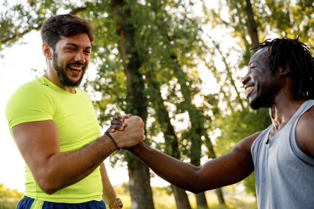 istock Two young male joggers greeting each other in nature 1979254339