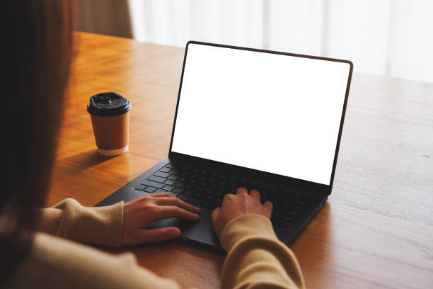 istock Mockup image of a woman working and typing on laptop computer with blank white desktop screen at home 1979263235