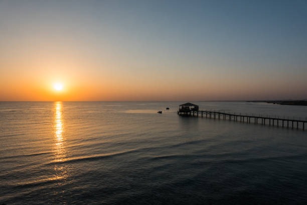 istock long jetty and small waves during a warm sunrise on vacation 1979296275