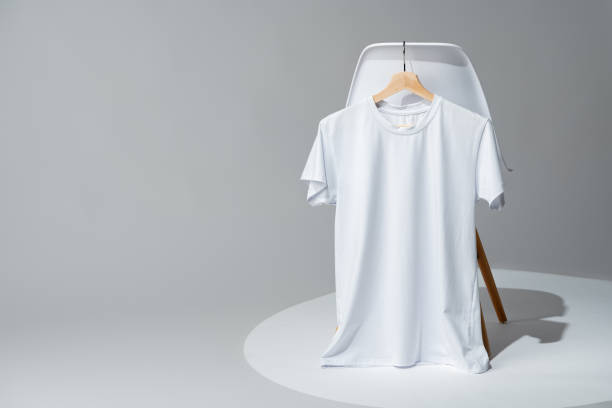 istock Blank white T-shirt hanging on a chair on white background 1979329116