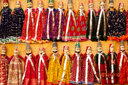 Colorful traditional handmade puppet dolls of India being sold at a street side shop at Jaisalmer, Rajasthan