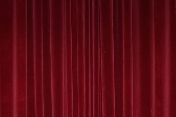 istock Vertical folds on red velvet curtains for background and design 1979334794