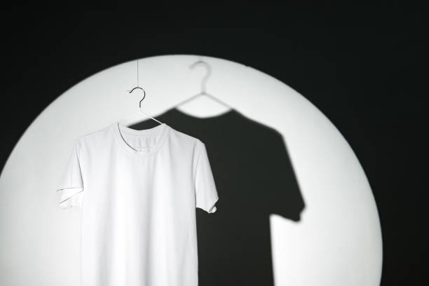 istock Blank T-shirt hanging in a spotlight in studio 1979337853