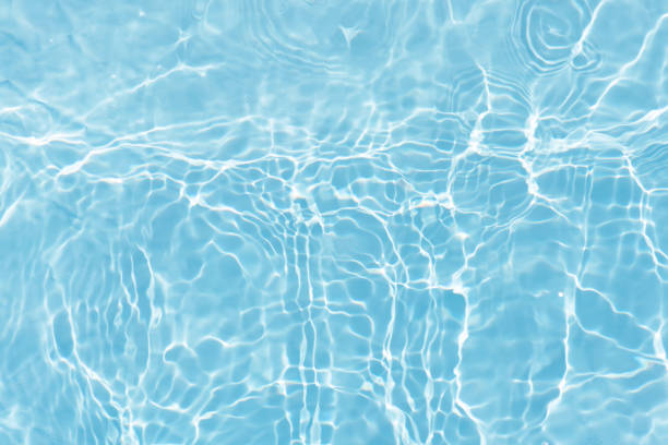 istock Water surface. Bluewater waves on the surface ripples blurred. Defocus blurred transparent blue colored clear calm water surface texture with splash and bubbles. Water waves with shining pattern. 1979337866