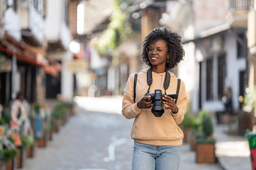 African american female tourist walking at a historical city street
