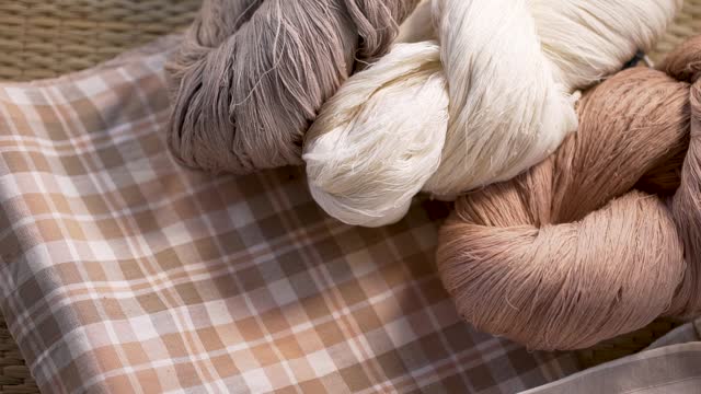 Close-up of yarn from various natural colored cotton fabrics.