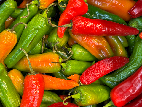 Background of ripe orange and red chilli