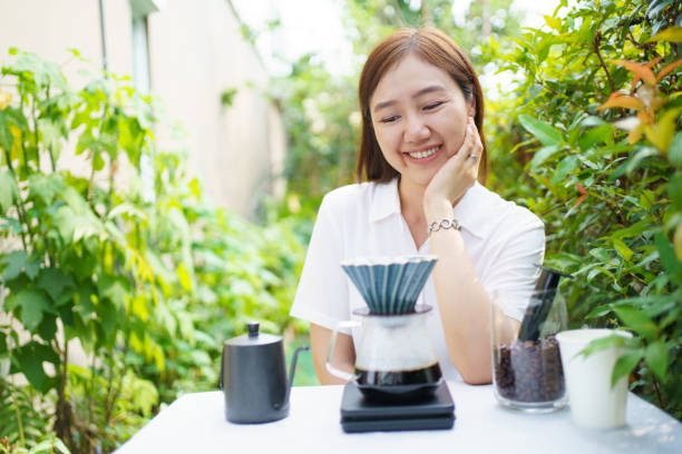 istock Woman making and drinking a craft coffee. 1979434847