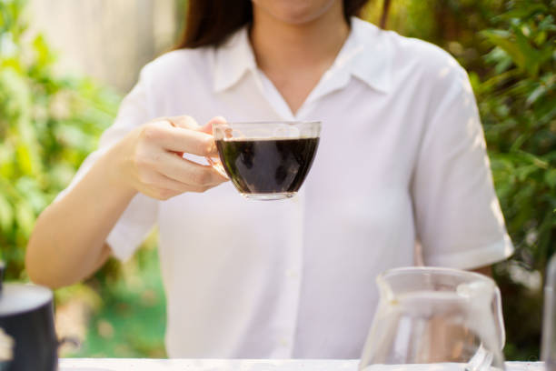young pretty woman drinking coffee , warm tones