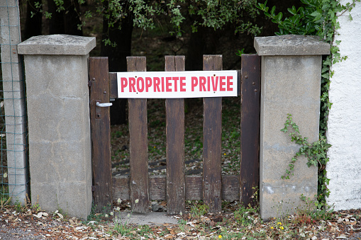 Red Private Property sign french text panel in France Propriete Privee on wooden door