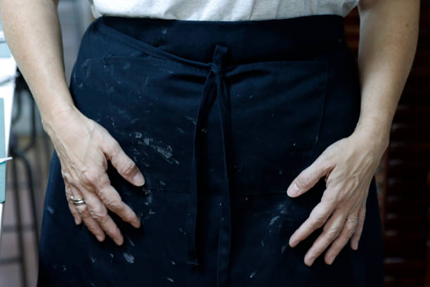 istock Close-up of a person's hands in an apron 1979444364