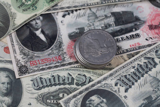 istock Old west US banknotes with silver dollar coins 1979455568