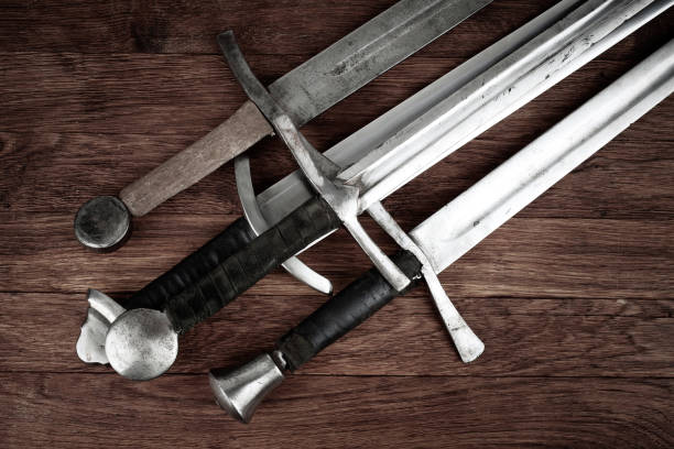 Medieval swords on wooden backgrond.