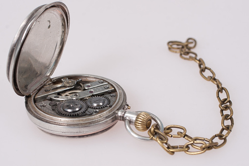 Antique pocket watch on old papers background