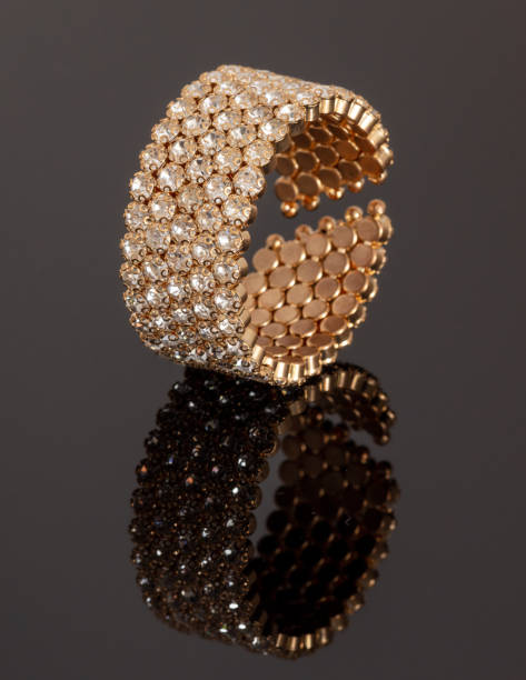 istock Gold bracelet with stones on a black background with reflection 1979476584