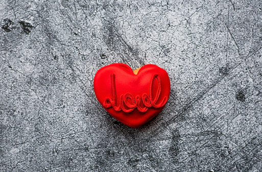 Heart shaped Valentine’s day gift box on red background