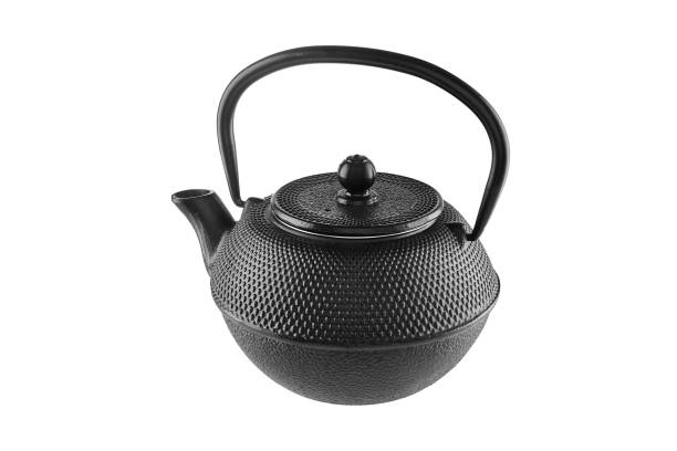 istock Cast iron black kettle for brewing tea isolated on white background 1979494523