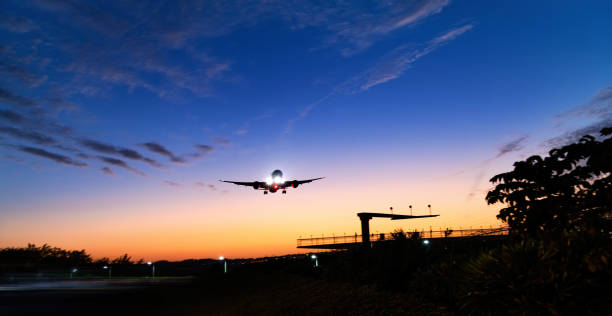 istock Airplane flying over air traffic control tower 1979496665