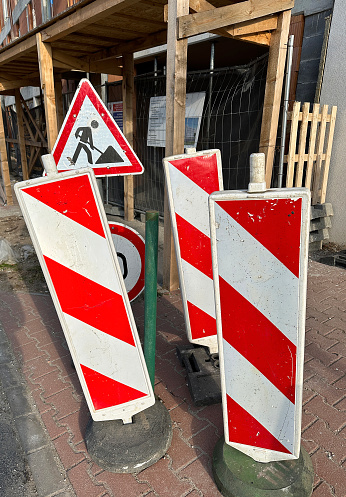 Traffic signs on the road in front of a construction site