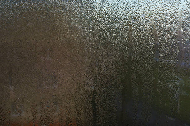 istock The background of a textured wet glass window 1979514659