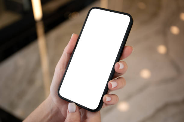 istock Female hands hold phone with isolated screen on background street 1979516209