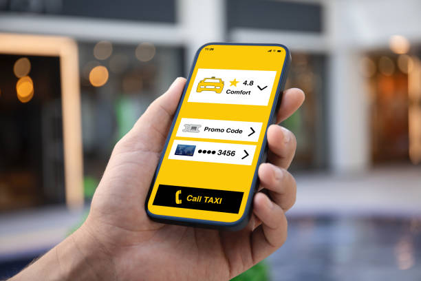 Man hand holding phone with taxi call application on screen stock photo