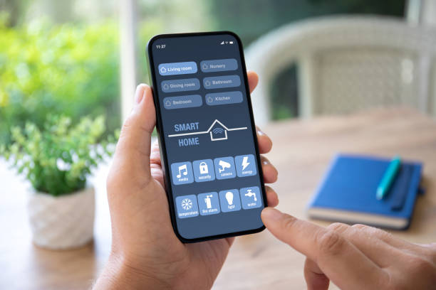 istock man hand hold phone with application smart home on screen 1979563629