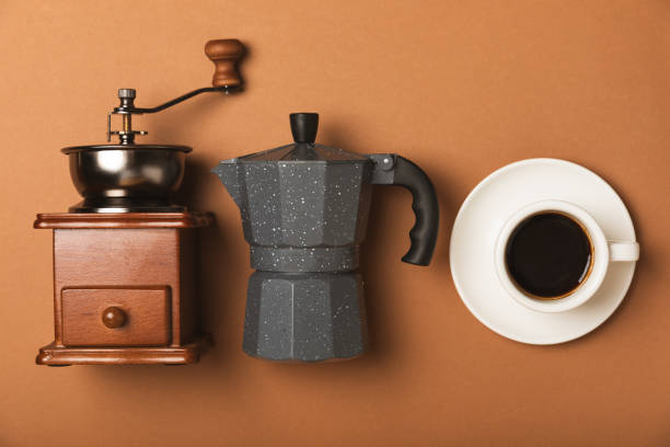 istock Ingredients for making coffee. Moka pot, Turkish coffee pots (cezve), coffee grinder with coffee beans, milk, sugar and spices on a white background. Drink preparation concept. Flat Lay.Copy space. 1979573687