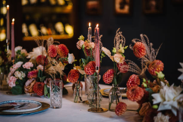 istock Wedding set up, reception closeup. Festive dinner table decorated with flower and greenery, candles. Birthday celebration in restaurant. Serving, setting table. Plate, silverware cutlery, glasses. 1979576851