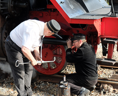 Loenen, Netherlands Sep 8 2019 Two volunteers are carrying out the final inspection before this steam locomotive can drive away