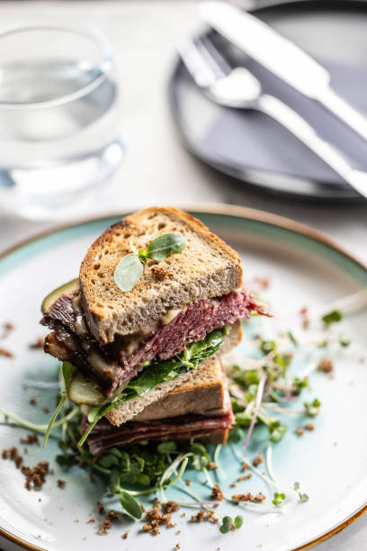 istock New York sandwich with pastrami, sauce and herbs. Fast food concept. 1979615744