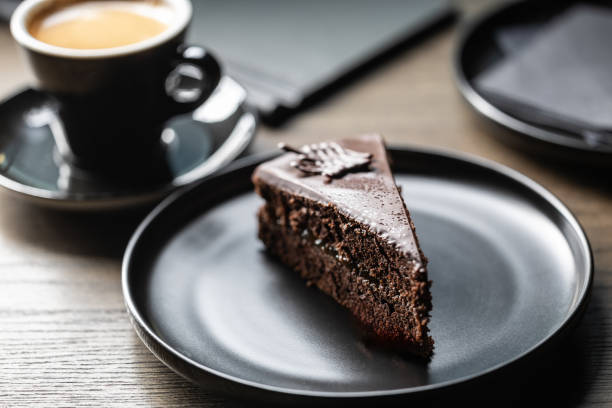 Sacher cake with coffee on the table in the cafe.