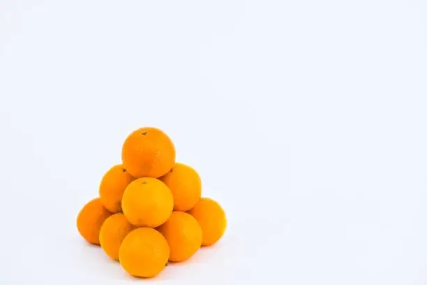 A delightful composition capturing the freshness of mandarins against a clean white backdrop.