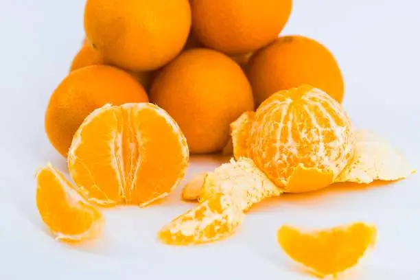 A delightful composition capturing the freshness of mandarins against a clean white backdrop.