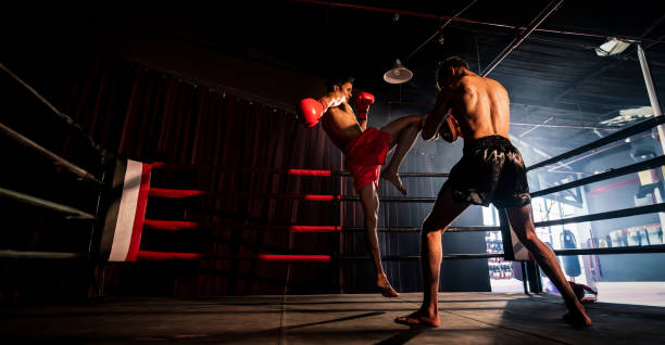 istock Asian and Caucasian Boxer unleash knee attack in training. Spur 1979642443